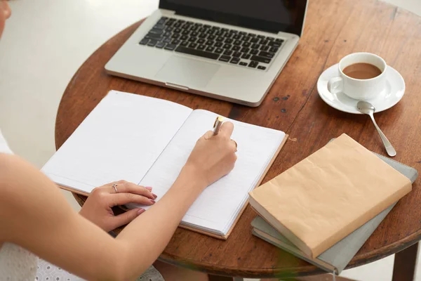 Female Student Writing Notes Her Textbook Sitting Cafe Table Laptop Royalty Free Stock Photos